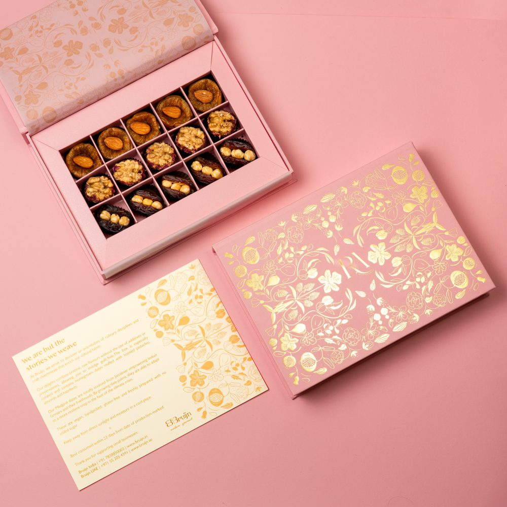 a customised box with bride and groom's logo with stuffed walnuts, dates with hazelnut and figs with salted, caramel almonds