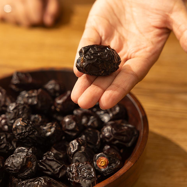 Hand holding Ajwa dates