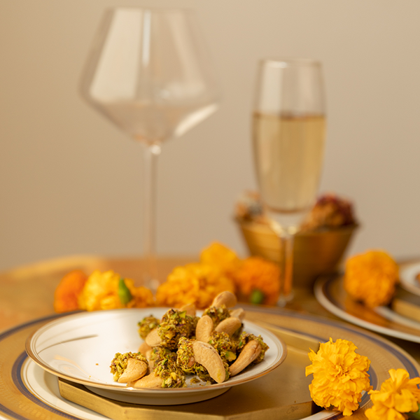 Salted roasted cashews dipped in caramel pistachio bits for Indian weddings and festivities