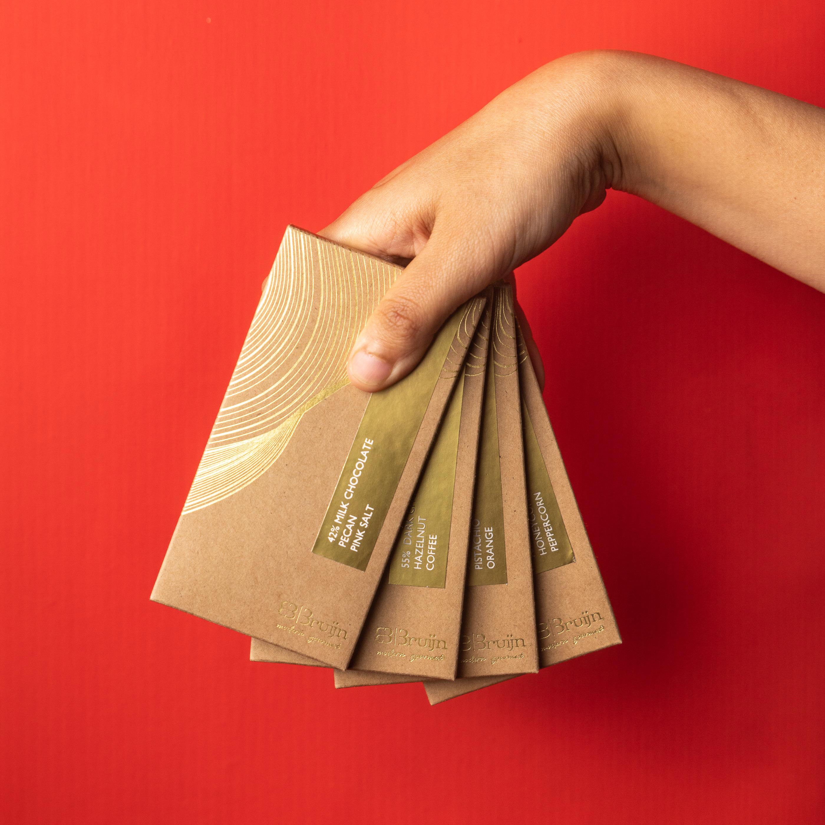 Smooth, thin chocolate bars in bold flavors: Pecan & Pink Salt, Coffee & Hazelnut, Honeycomb & Peppercorn, Pistachio & Orange Zest.