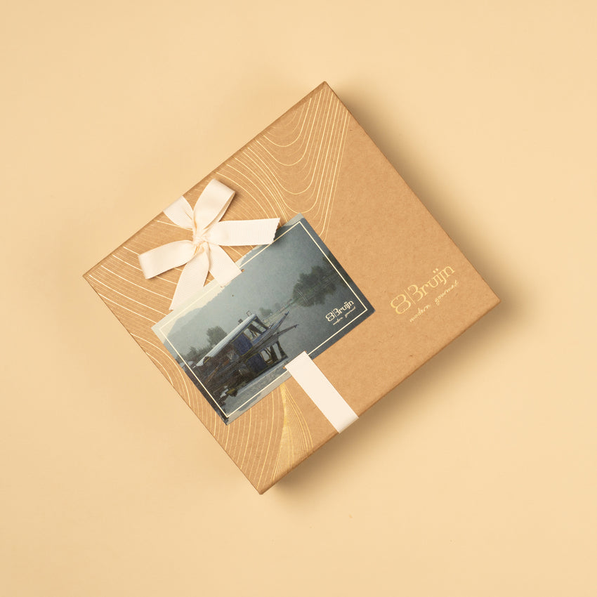 Essence of Kashmir Gift box with a bow and card on a beige background