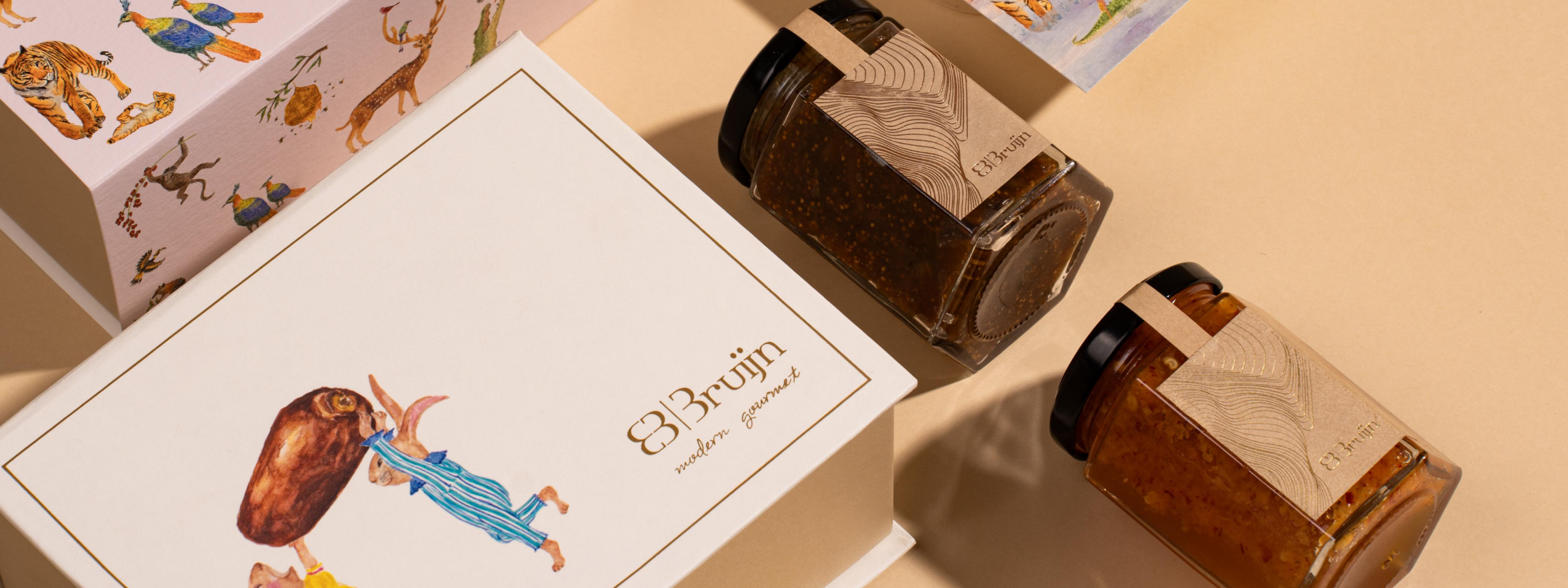 Fig and Rosemary Preserve kept alongside a jar of hot honey butter as options for a birth announcement box