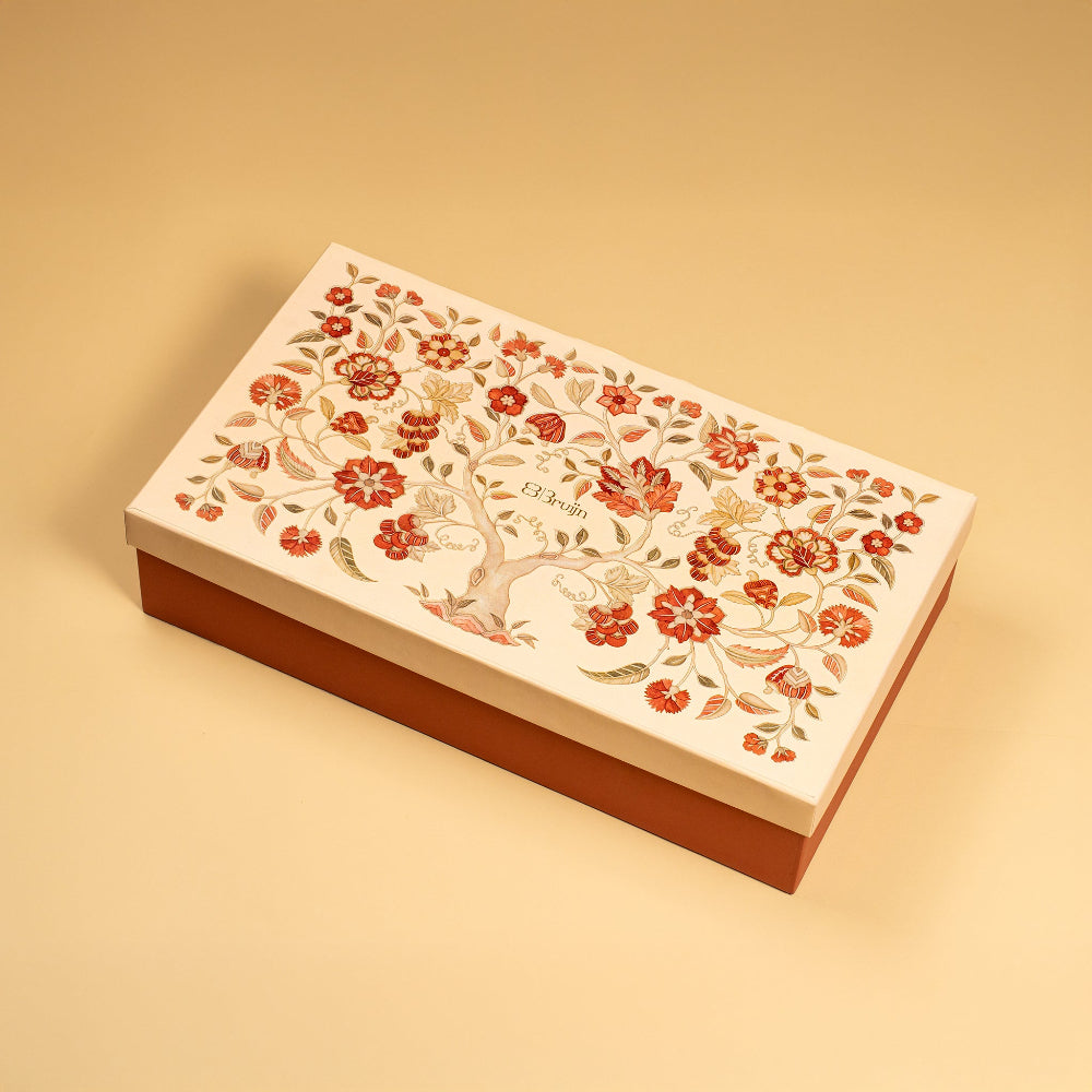 A large gift box that holds four large jars and 30 pieces of dried fruit like stuffed dates, figs and truffles