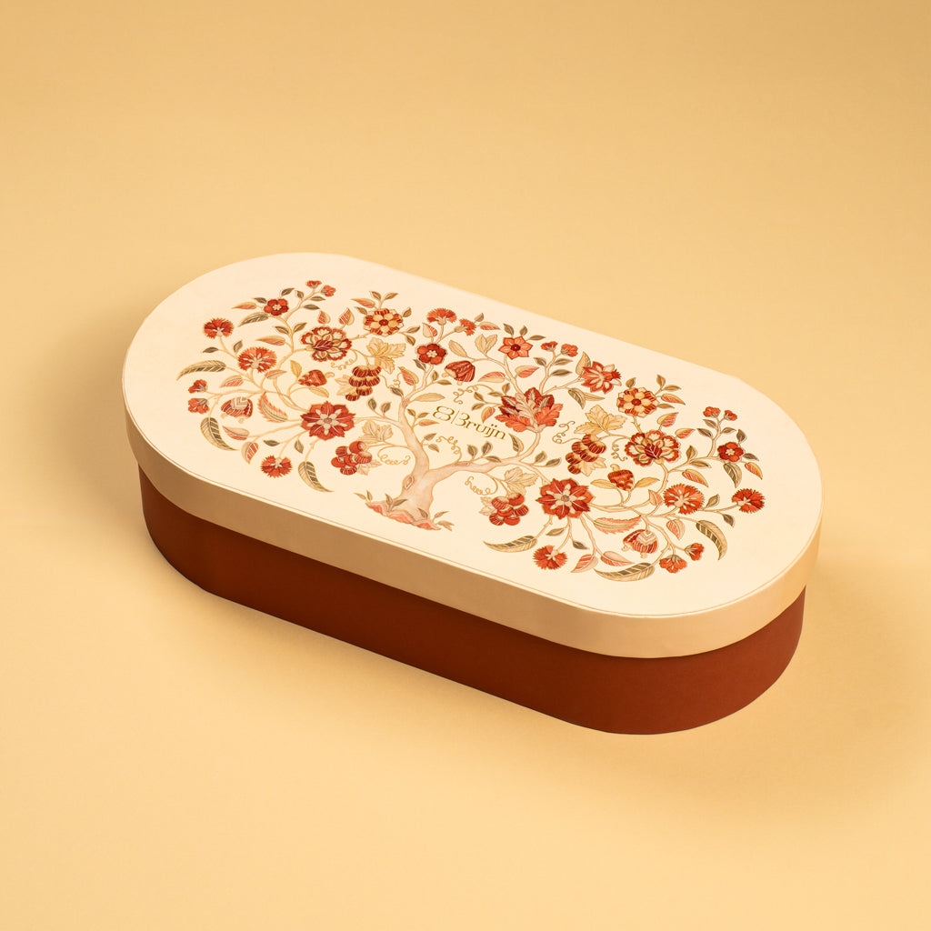 A handprinted illustration drawn by Jaamuni Samundar that holds 16 dried fruits like dates and figs stuffed with nuts along with two large jar of roasted nuts