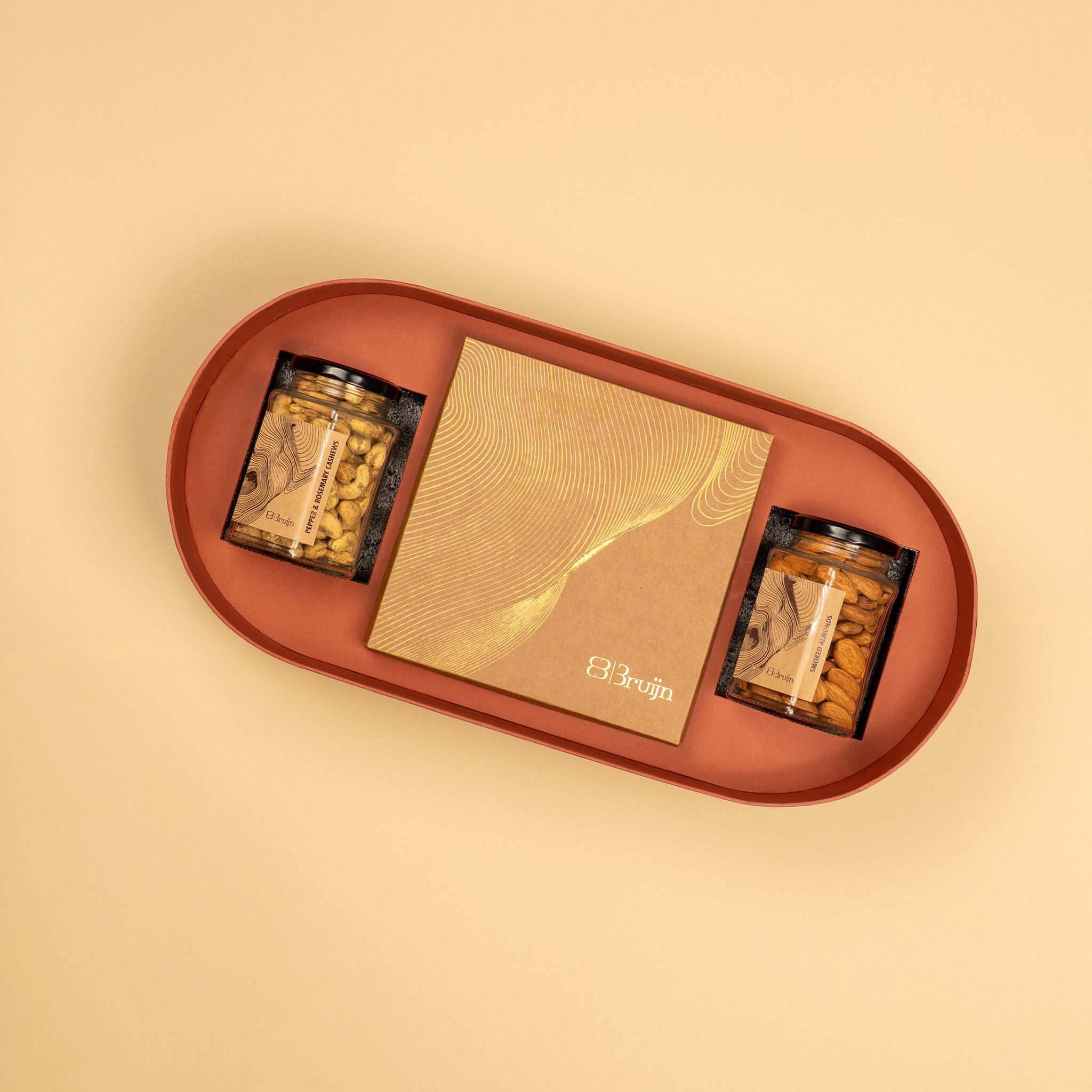 A handprinted illustration drawn by Jaamuni Samundar that holds 16 dried fruits like dates and figs stuffed with nuts along with two large jar of roasted nuts