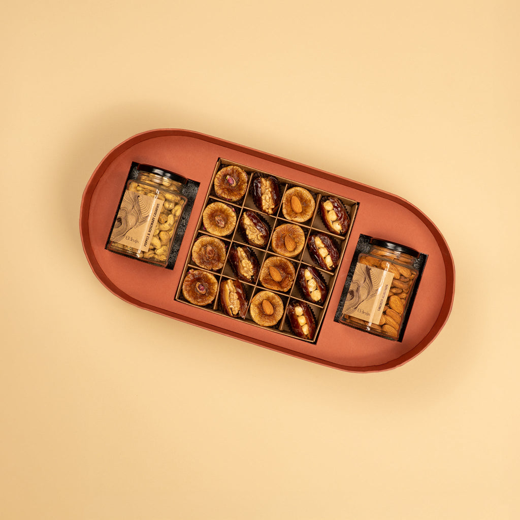 A handprinted illustration drawn by Jaamuni Samundar that holds 16 dried fruits like dates and figs stuffed with nuts along with two large jar of roasted nuts