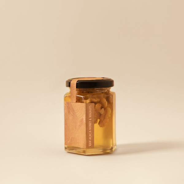 Glass jar with black lid on a beige background