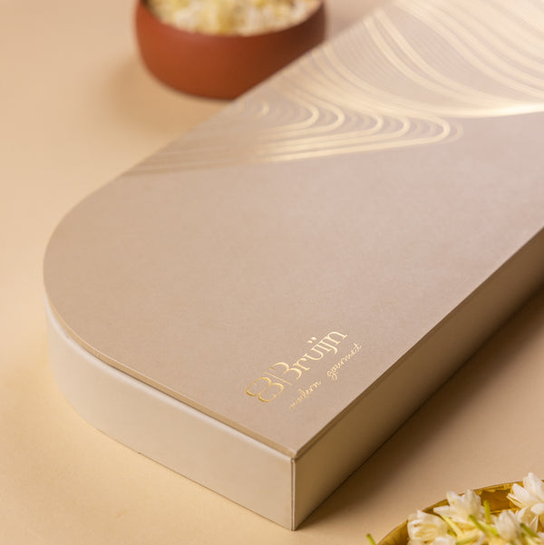 Angled view of elegant Signature Tray box with golden line art design.