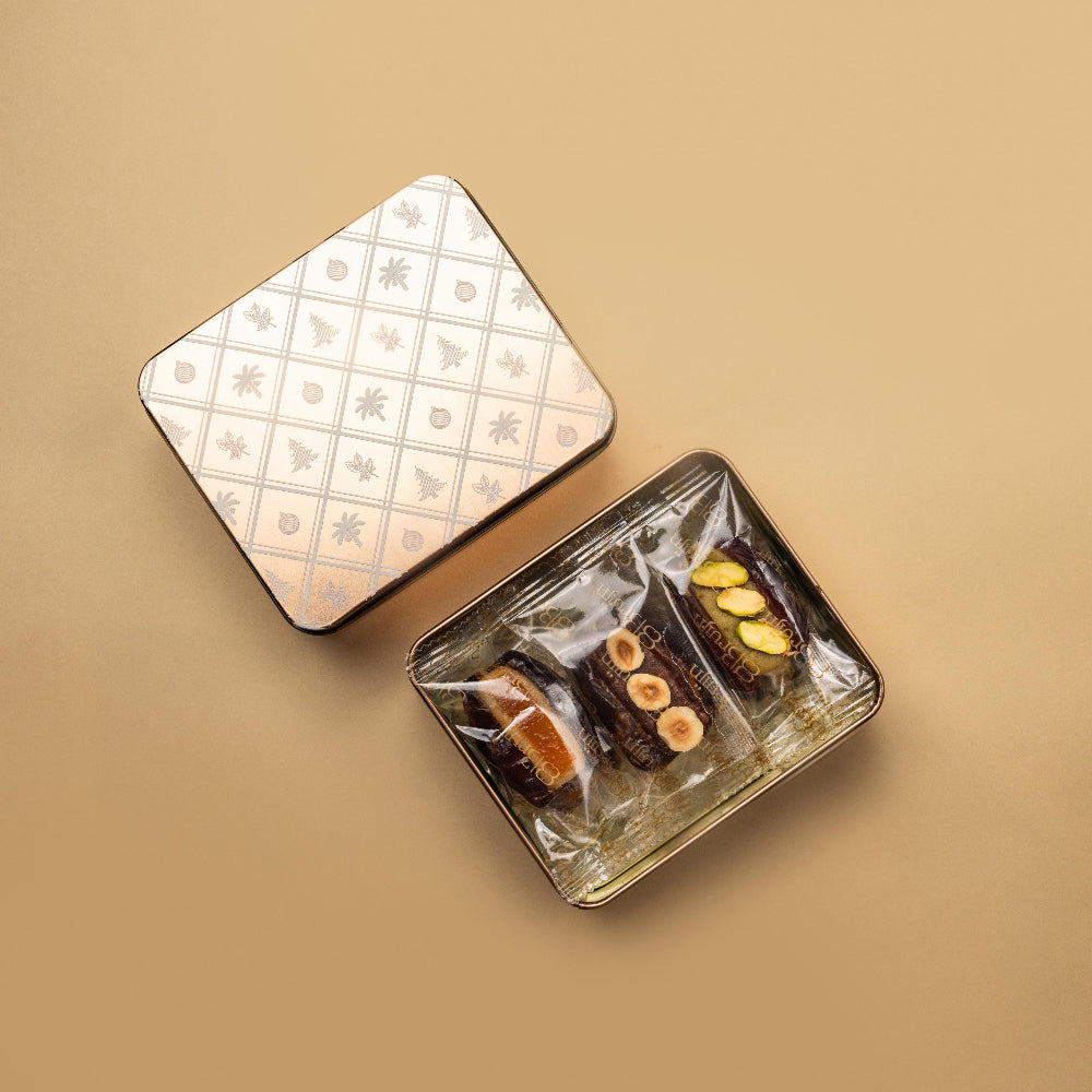 Medjool dates stuffed with artisanal marzipan flavours of pistachio, bitter almond, orange and chocolate in a Christmas tin