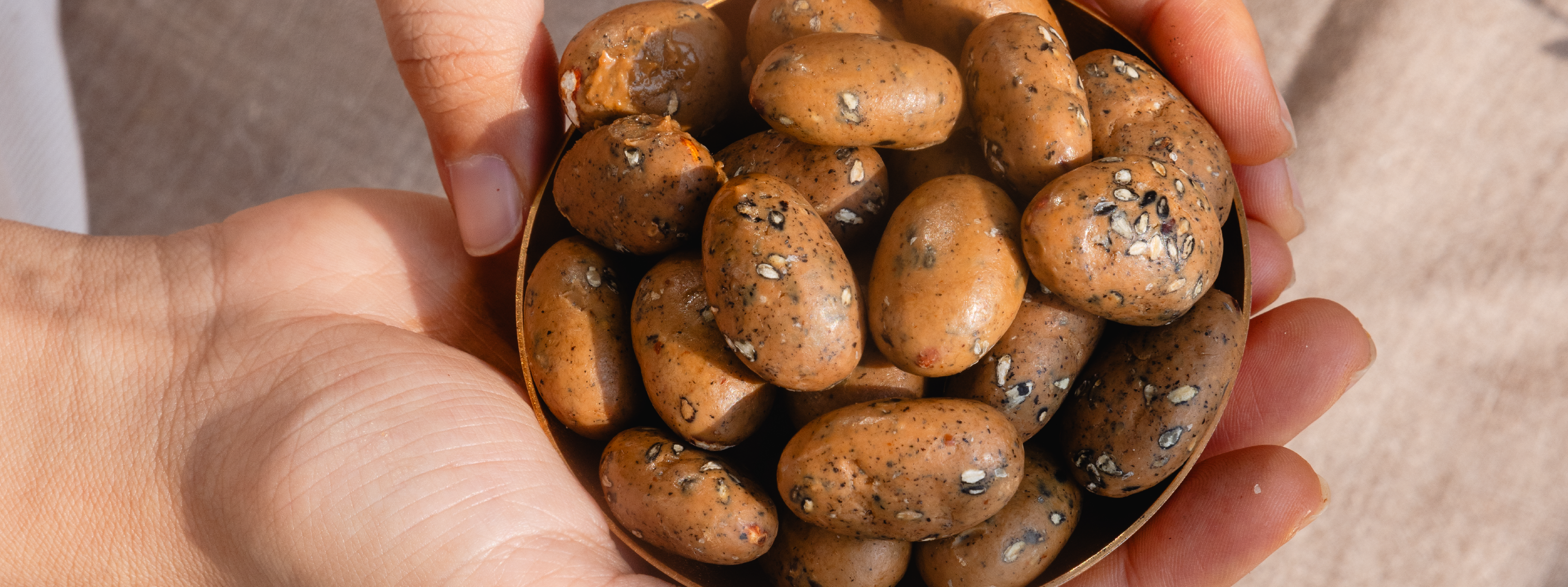 Black sesame and caramelised white chocolate coated almond dragees
