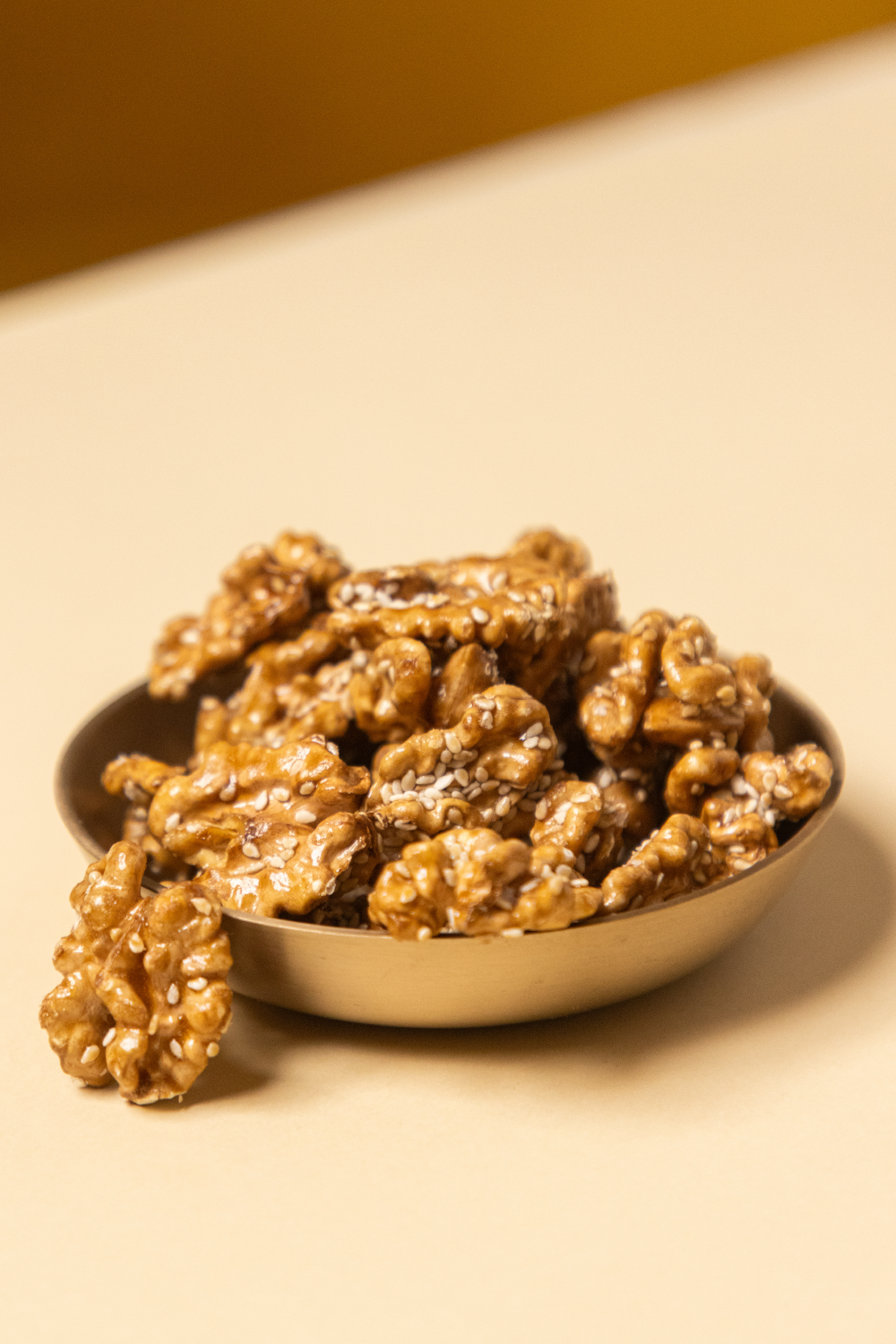 Roasted walnuts caramelised with date sap jaggery and sprinkled with white sesame