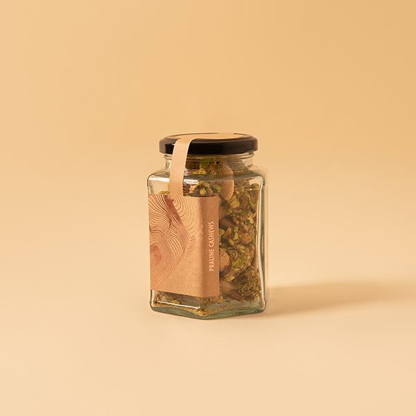 Salted roasted cashews dipped in caramel pistachio bits for Indian weddings and festivities