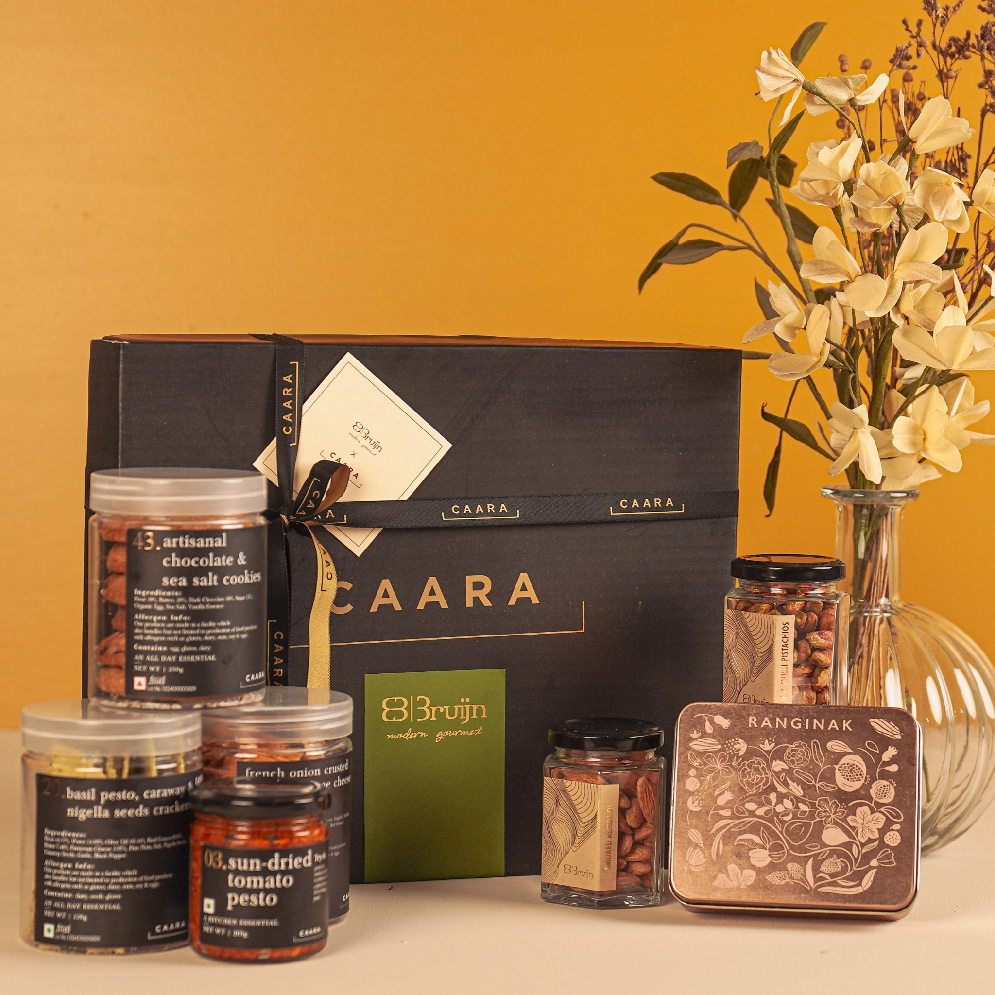 Gourmet gift set with jars and a box on a yellow background