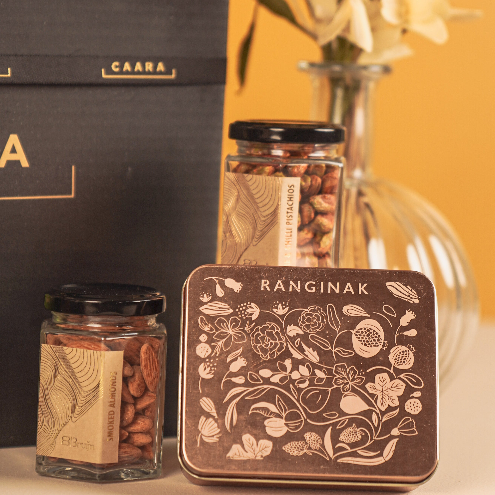 Jars of nuts and a decorative tin with 'RANGINAK' 