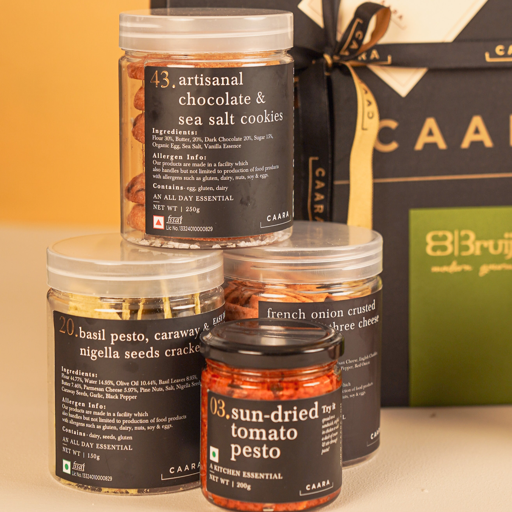 Three jars of sun dried tomato pesto, chocolate and sea solt cookies, basil pesto