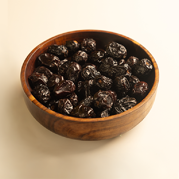 Wooden bowl filled with ajwa dates