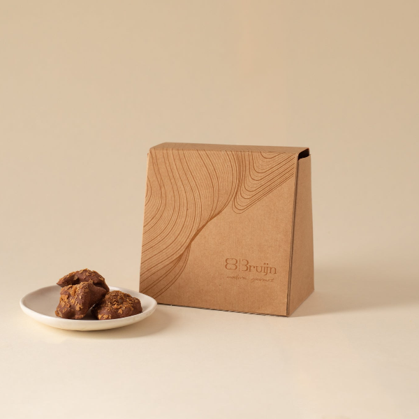 Brown gift box with a white ribbon on a beige background