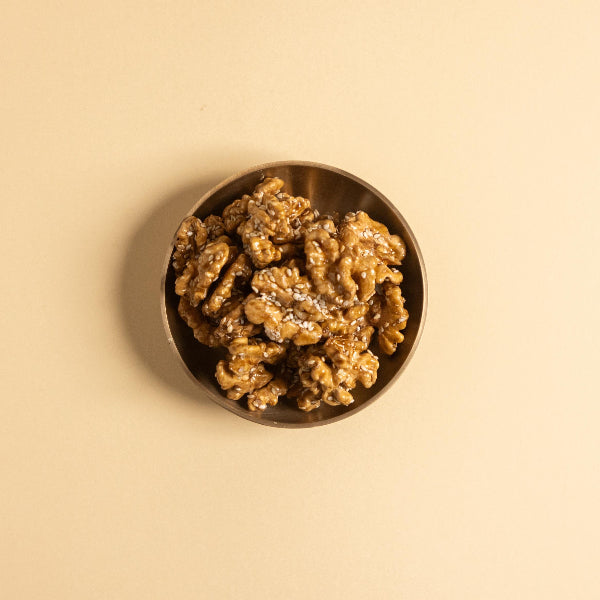 Roasted walnuts caramelised with date sap jaggery and sprinkled with white sesame