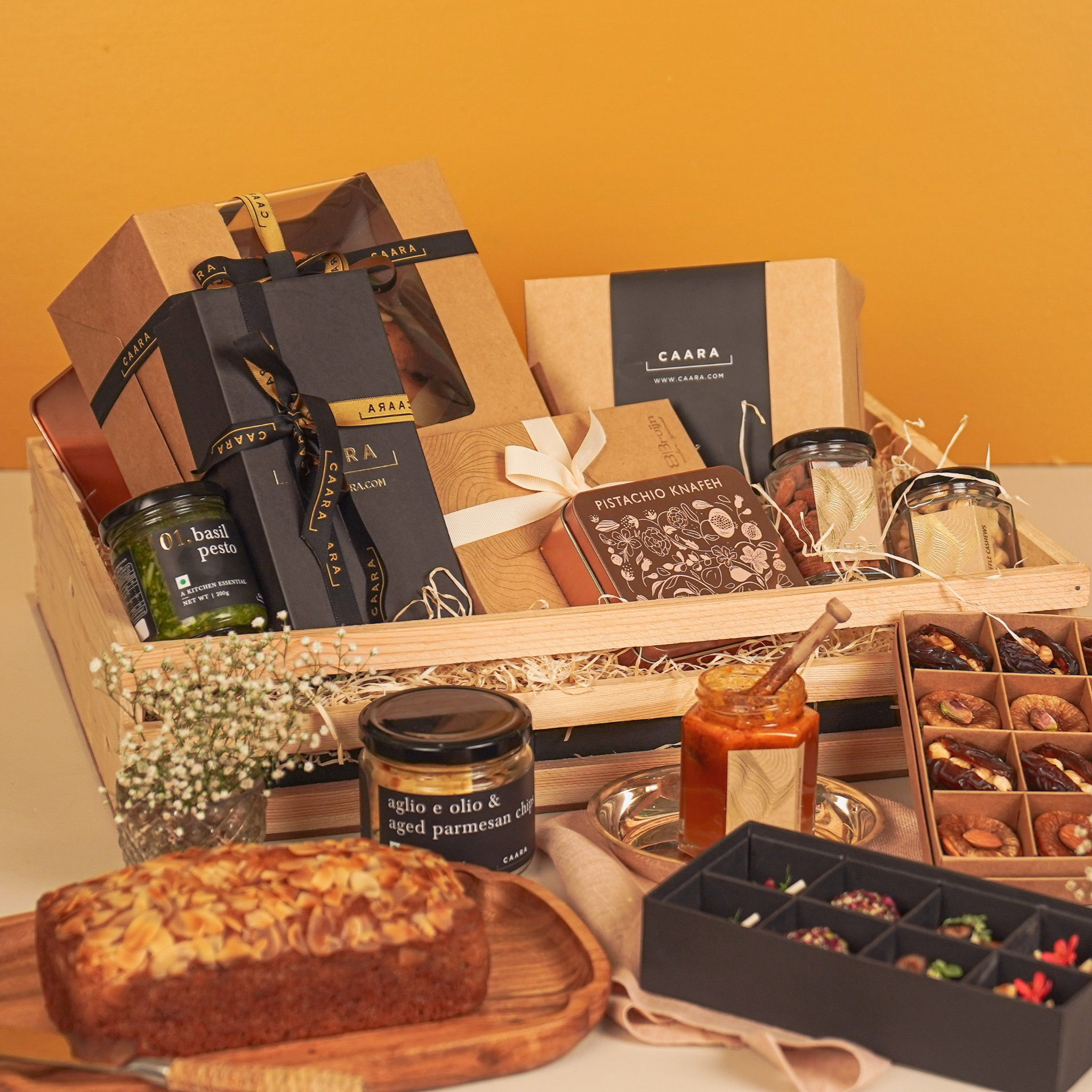 Gourmet gift basket with various items including a loaf of bread, jars, and a box 
