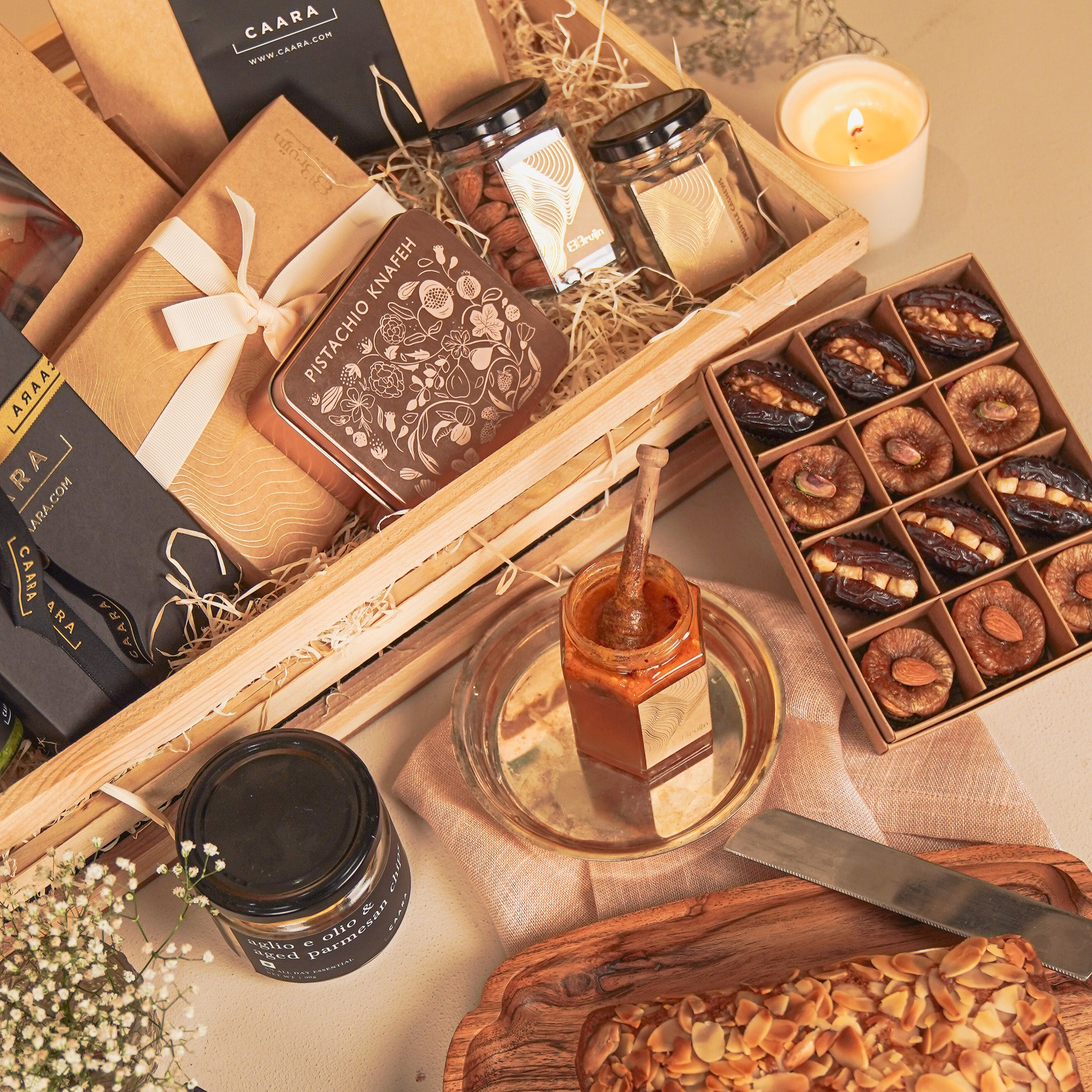 Gift basket with honey, dried fruits, and other items on a wooden surface.