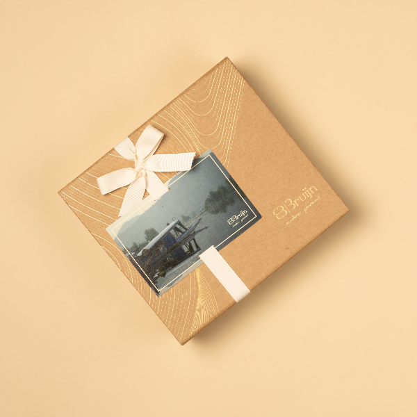 Essence of Kashmir Gift box with a bow and card on a beige background