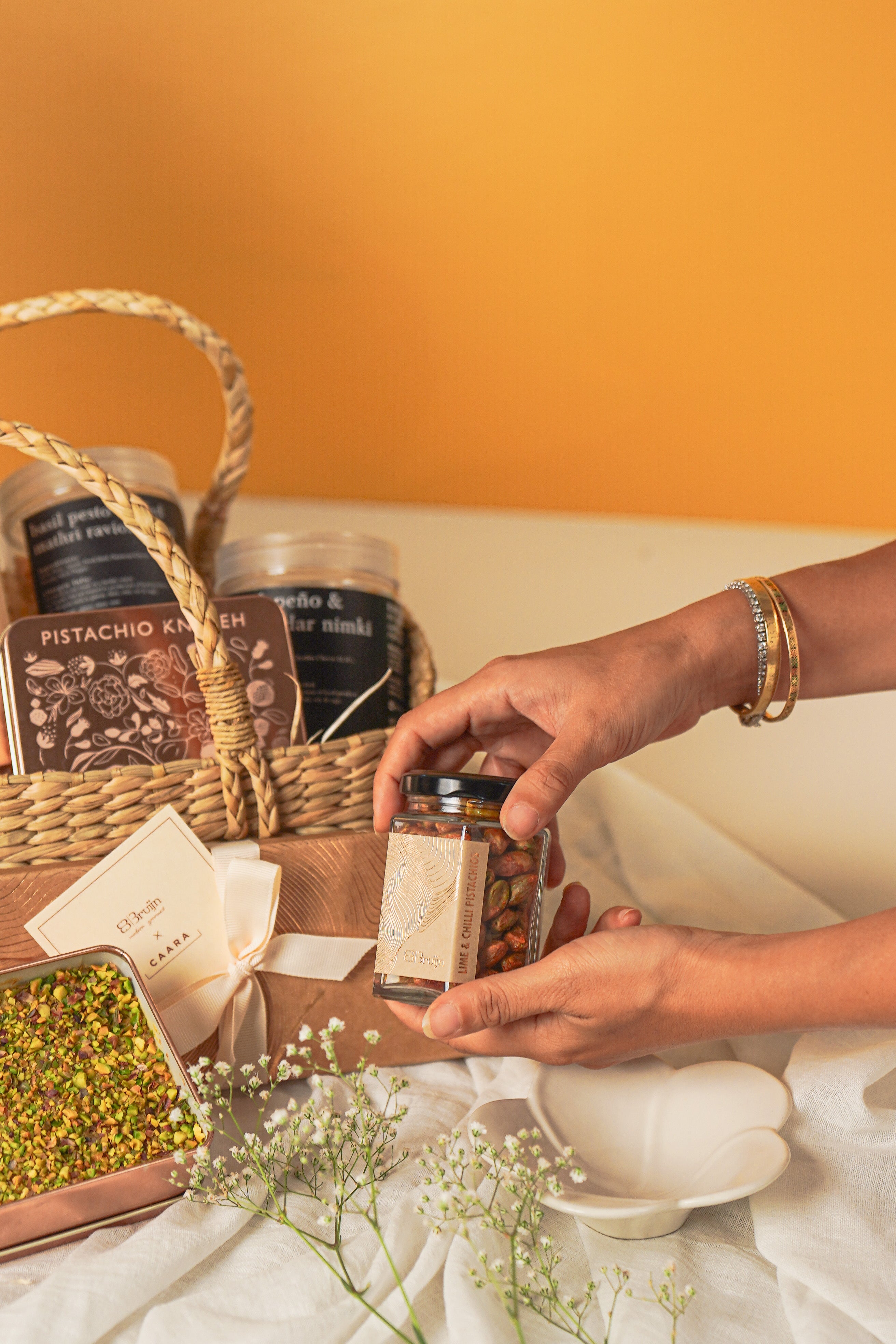 Person holding a spice jar with a basket of tea 