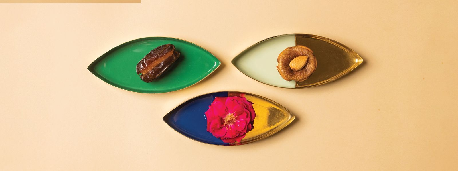 Individual dried fruits like dates and figs laid out on platters