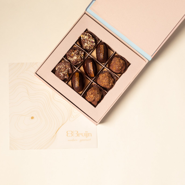 A box of 9 items including chocolates and dates