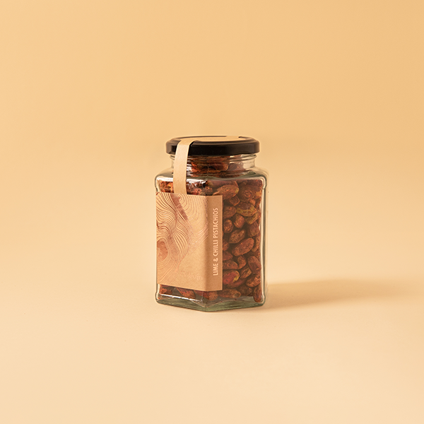 Roasted pistachio kernels flavoured with chilli and lime accompanying a light summer drink