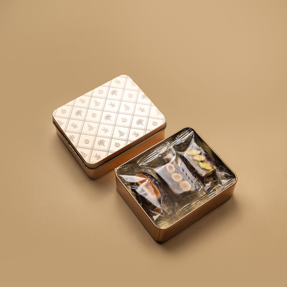 Medjool dates stuffed with artisanal marzipan flavours of pistachio, bitter almond, orange and chocolate in a Christmas tin 