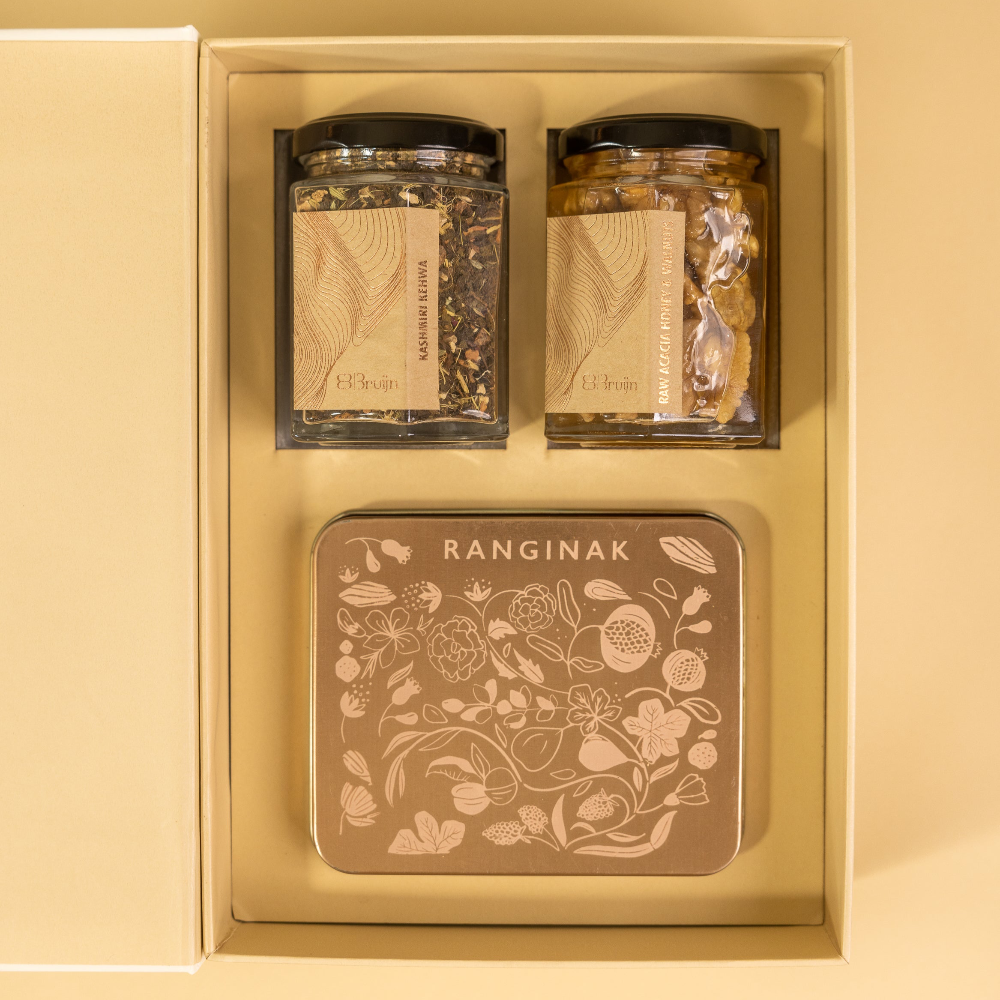 A birth announcement box with honey and kehwa and delicacy like Ranginak that has dates, walnuts and spices.