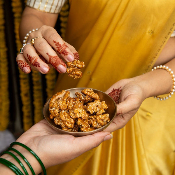 Roasted walnuts caramelised with date sap jaggery and sprinkled with white sesame