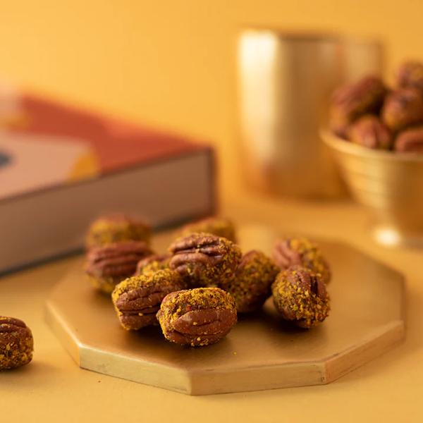 American pecans stuffed with a pure date and cardamom paste for Indian weddings and festivities 