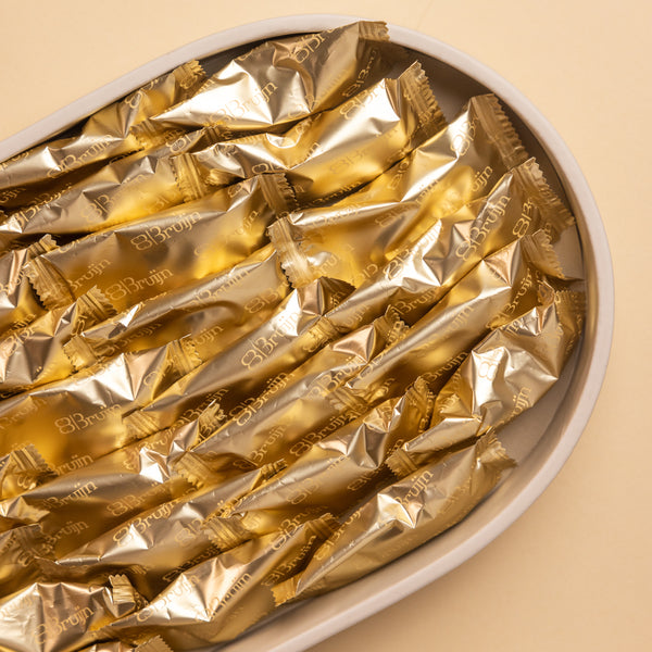 Top view of Signature Tray with individually wrapped Bruijn Medjool dates in golden foil.