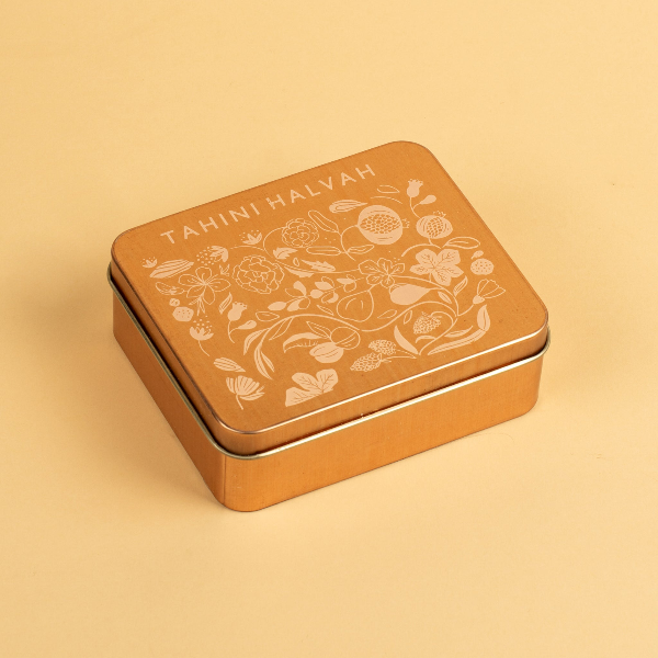 Tahini Halvah tin with floral design on a beige background