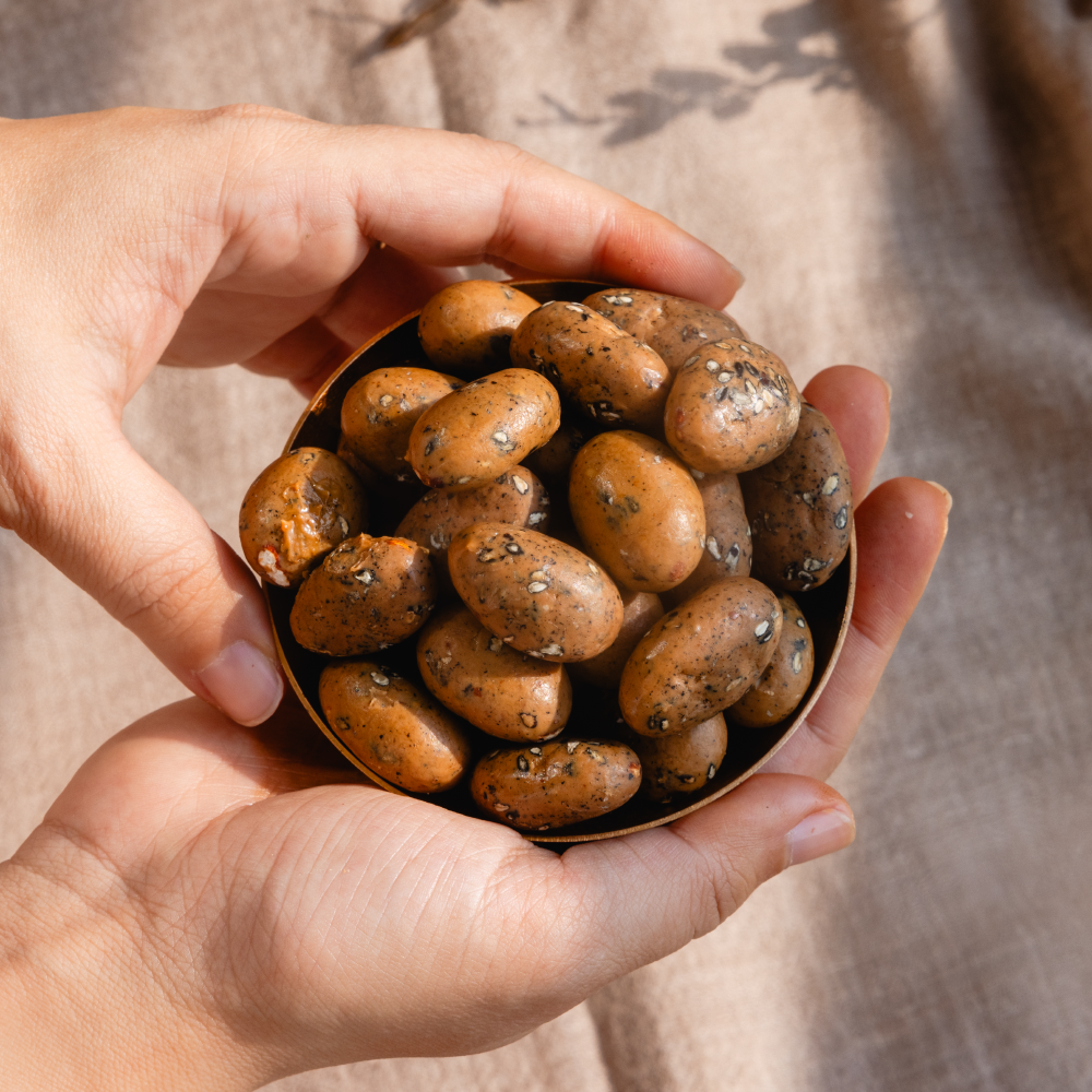 Black sesame and caramelised white chocolate coated almond dragees 