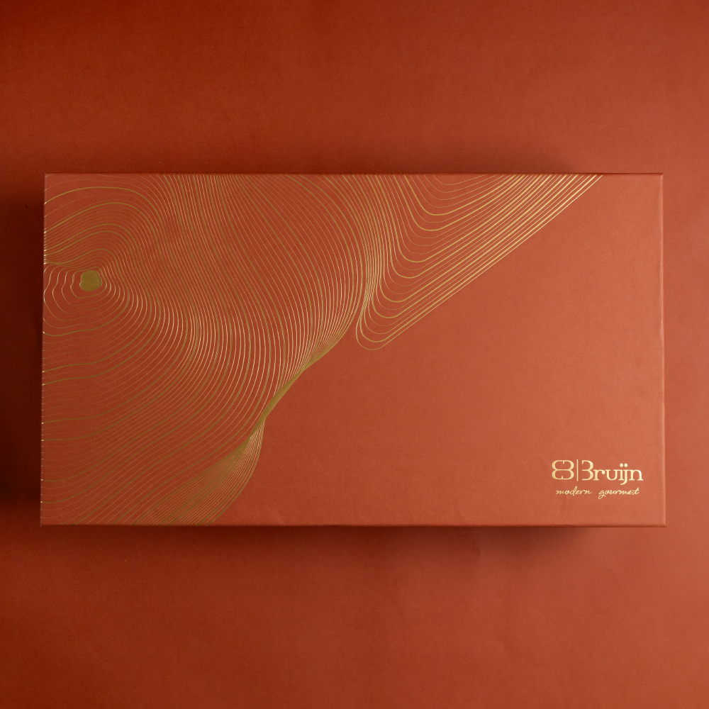 A large gift box that holds four large jars and 30 pieces of dried fruit like stuffed dates, figs and truffles