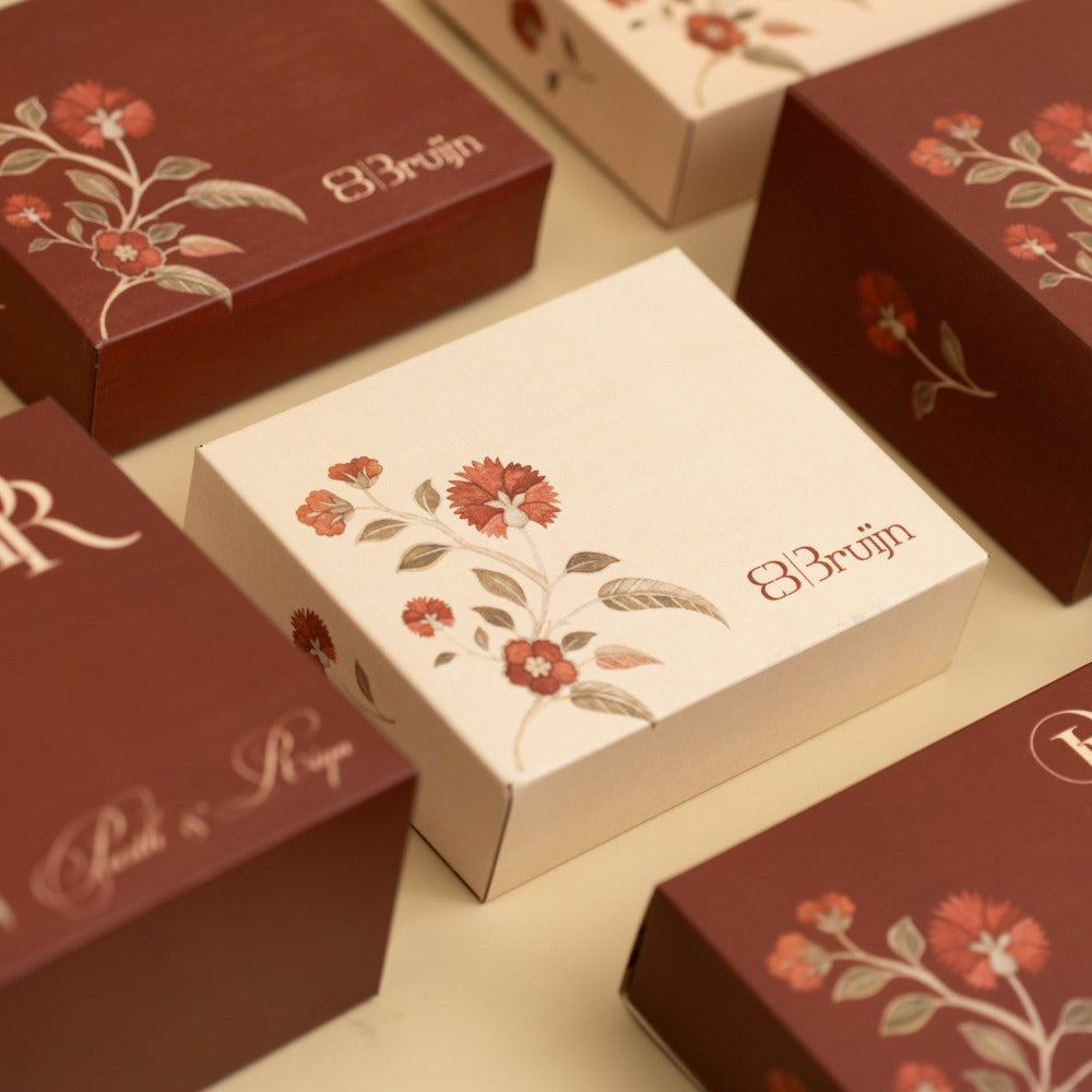 Decorative boxes with personalized wedding logos for in room hampers. containing dried fruits.