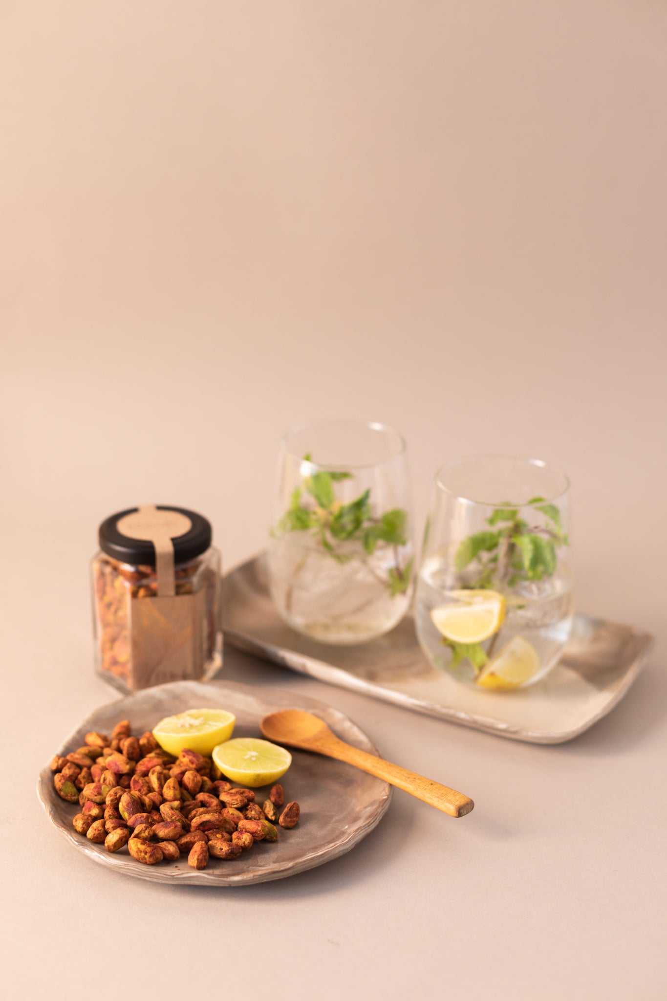 Roasted pistachio kernels flavoured with chilli and lime accompanying a light summer drink