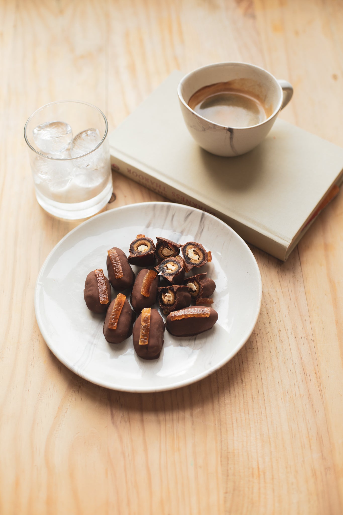 Stuffed dates dipped in dark craft chocolate topped with candied orange peels. A favourite coffee snack.